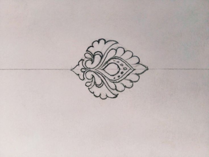 a drawing of a decorative design on a white paper sheet with black ink in the middle