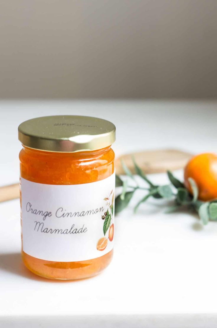 a jar of orange marmalade next to an orange