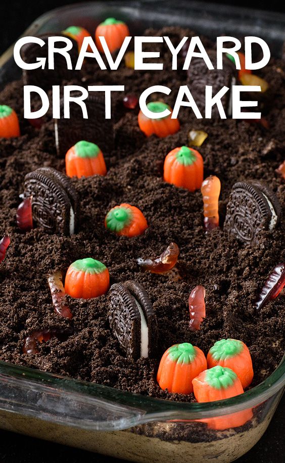 an image of graveyard dirt cake with oreos and carrots in the soil for halloween