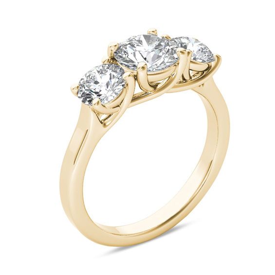 three stone engagement ring in yellow gold with diamonds on the sides and four stones at the top