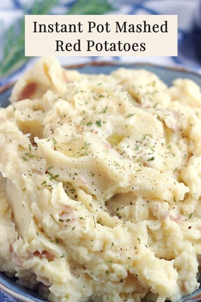 mashed potatoes in a blue bowl with the words instant pot mashed red potatoes