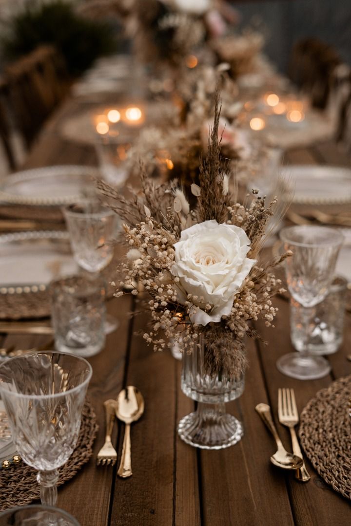 the table is set with silverware and flowers