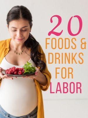 a pregnant woman holding a plate with raspberries and lettuce on it