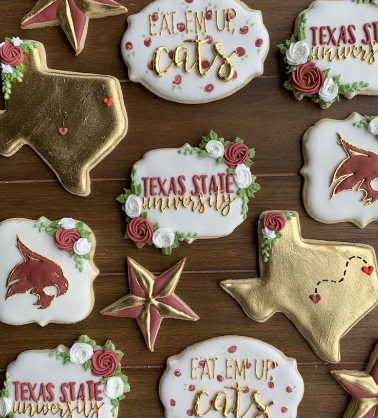 decorated cookies with texas state names and stars on them are arranged on a wooden table