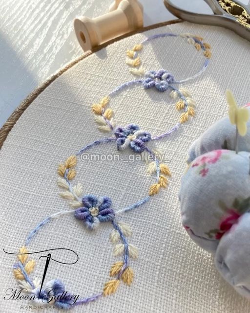 a close up of an embroidery project with scissors