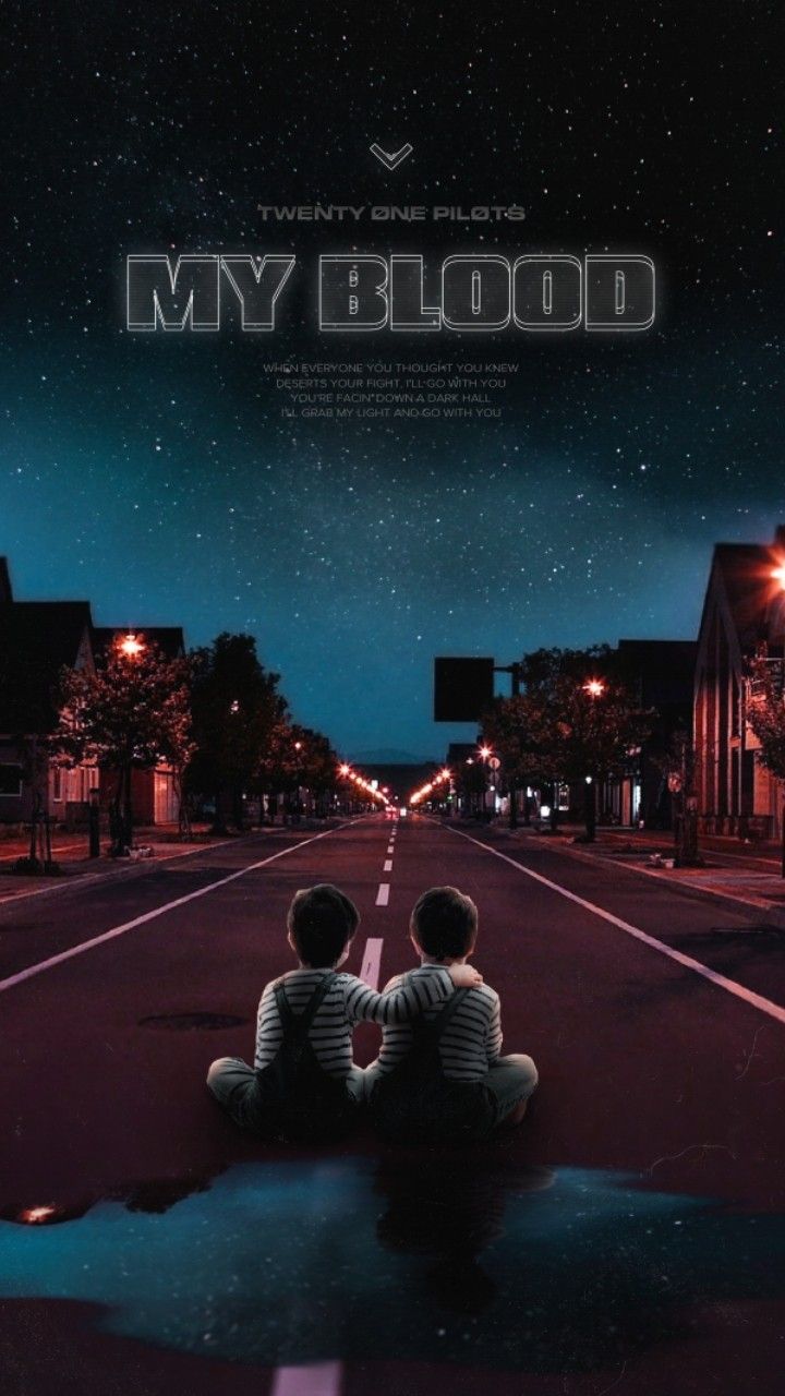 two young boys sitting on the side of a road at night looking up into the sky