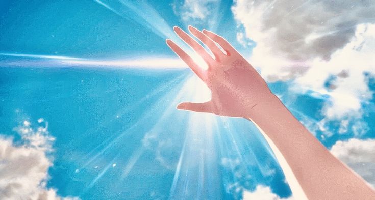 a person's hand reaching up into the sky with clouds and sun in the background