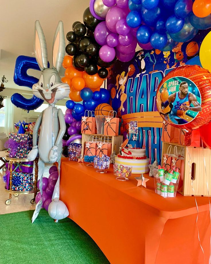 an orange table topped with lots of balloons