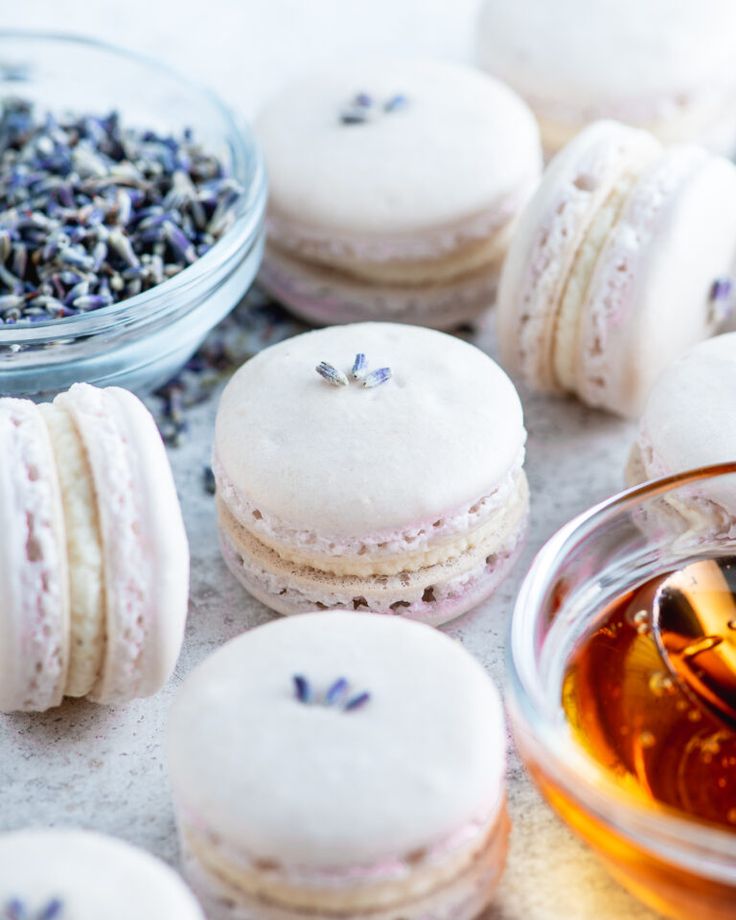 macaroons with lavender sprinkles and tea on a table next to them