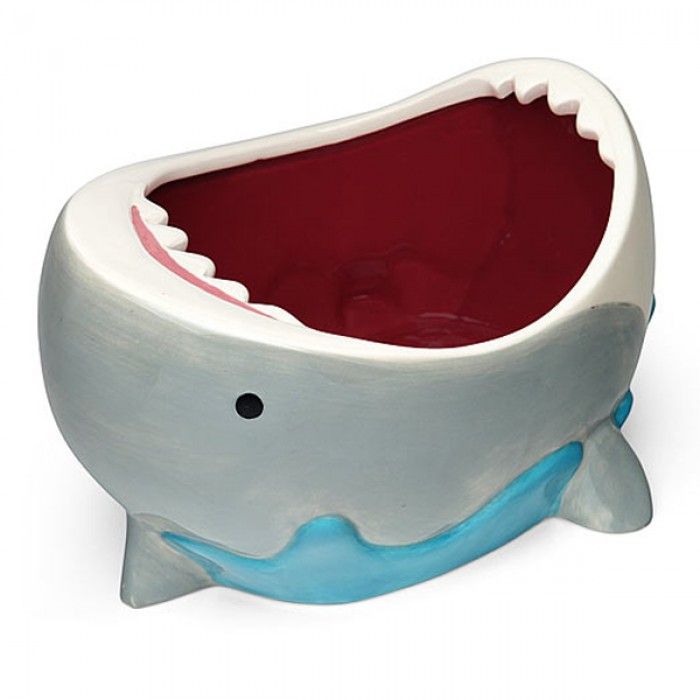 a ceramic toothbrush holder in the shape of a whale with its mouth wide open