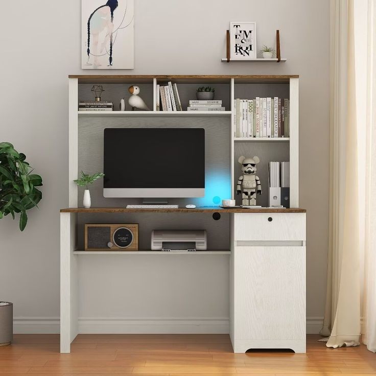 a computer desk with a monitor and speakers on it