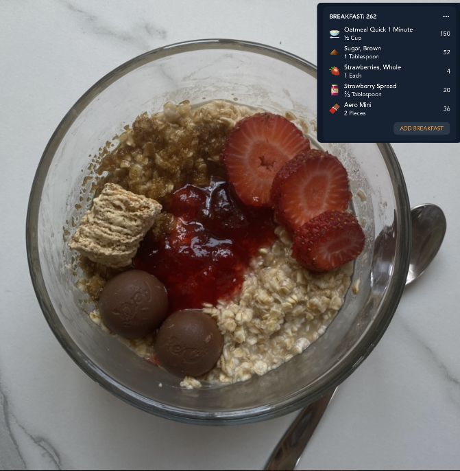 a bowl filled with oatmeal and strawberries on top of a table