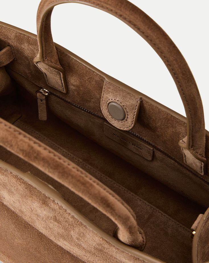 The aptly named Dash is a go-anywhere bag that takes you from work to weekends. Crafted from soft Italian suede with an adjustable belted strap, it’s designed with both a structured top handle and a removable shoulder strap for maximum versatility.Italian suedeLining: Italian suede13” L x 5.7” W x 8.7” HHandle drop: 4.7”; strap drop: 22.8”Store in a cool, dry place and wipe any surface dirt with a dry clothStyle #H2408HL106V015 Designer Suede Shoulder Bag With Detachable Strap, Luxury Suede Bag For Everyday Use, Luxury Suede Satchel For Daily Use, Modern Suede Satchel For Daily Use, Classic Suede Shoulder Bag With Top Handle, Suede Top Handle Satchel For Travel, Chic Suede Satchel With Double Handle, Suede Tote Bag With Detachable Strap, Modern Suede Bag With Detachable Handle