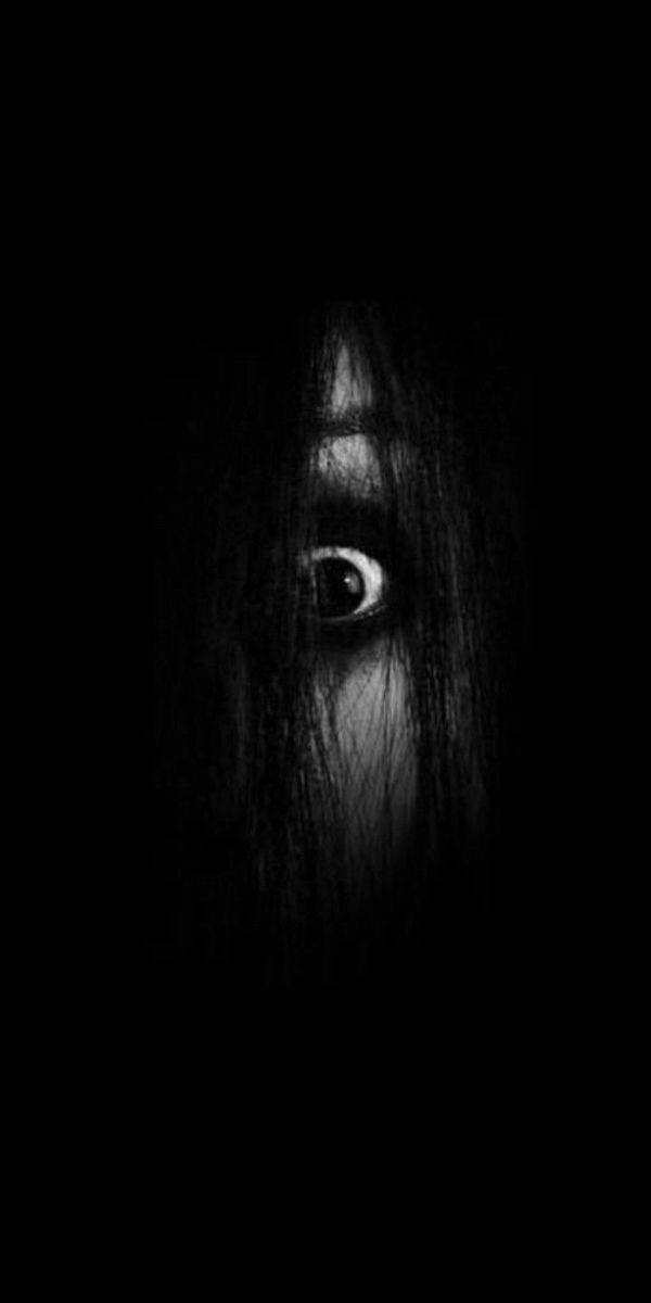 a woman's eye is shown in the dark