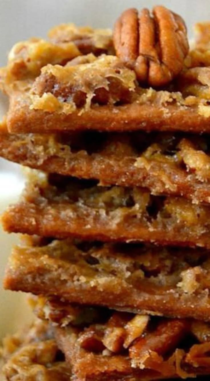 a stack of pecan cookies sitting on top of a white plate