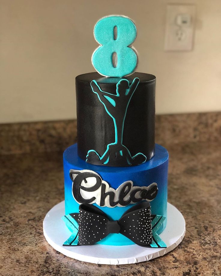 a blue and black cake with the number 8 on it