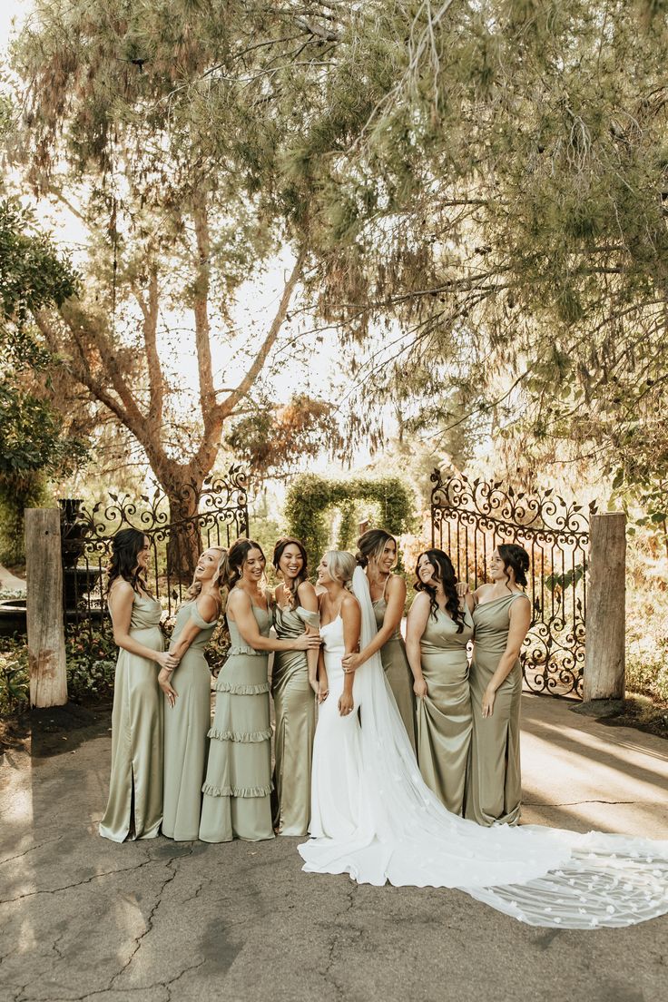 a group of women standing next to each other in front of a gated area