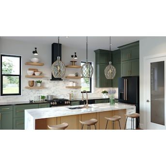 a kitchen with green cabinets and marble counter tops, hanging lights over the island area