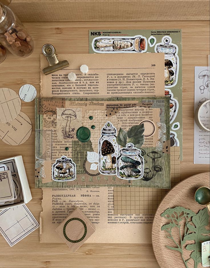 an assortment of paper and crafting supplies on a wooden table with scissors, tape measure, stamp pads, and other items