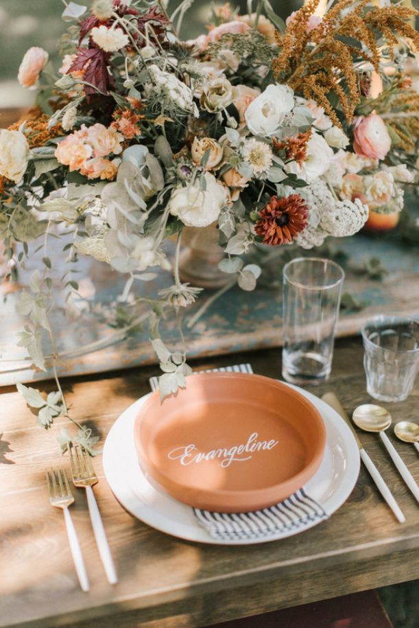 a table set with flowers and place settings for an elegant dinner party or brunch