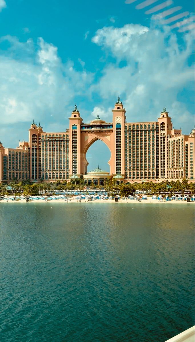 the palace hotel and casino from across the water on a sunny day with blue skies