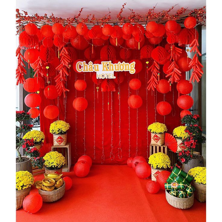 red and yellow decorations are on display in front of a red backdrop that says chau klong hotel