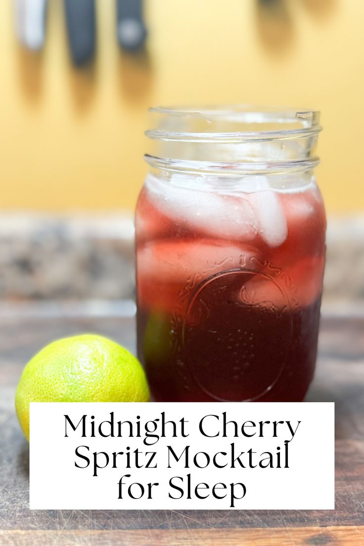 a mason jar filled with liquid next to a lime