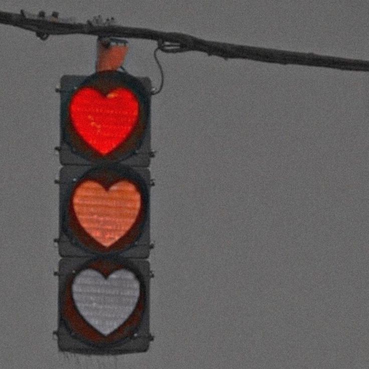 a traffic light with two hearts on it