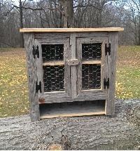 an old wooden cabinet sitting on top of a tree stump