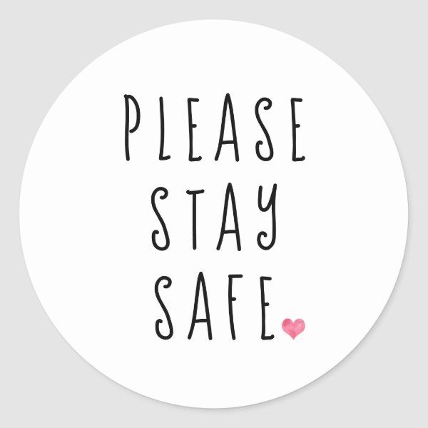 a round sticker with the words please stay safe in black and pink on it