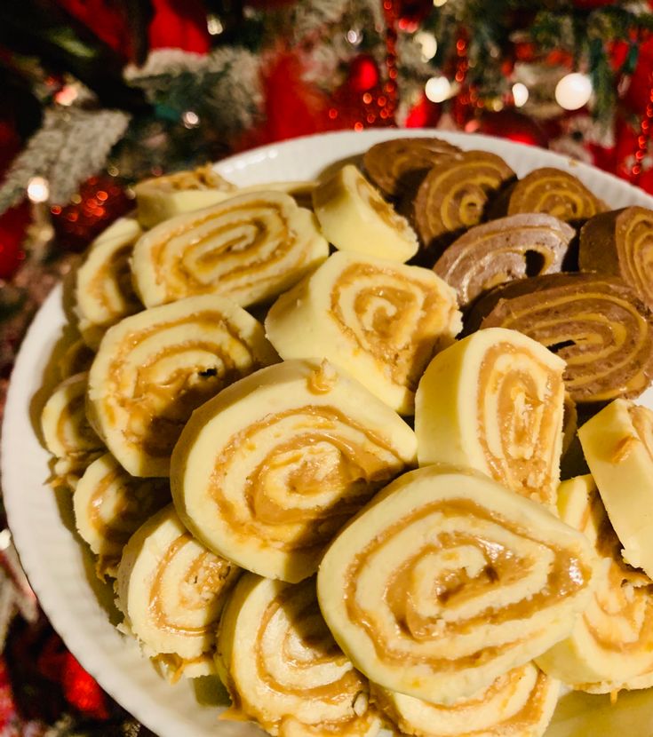 a white plate topped with lots of different types of pastries on top of a table