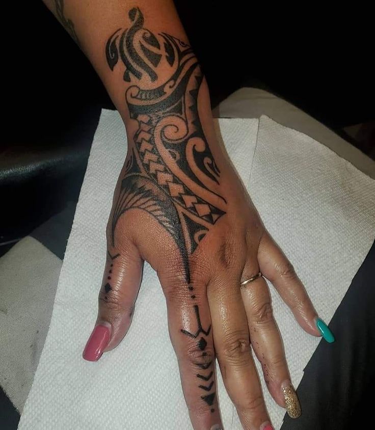 a woman's hand with a tattoo on it