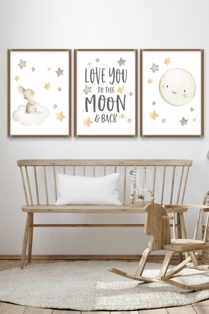 a baby's nursery room with two posters on the wall and a rocking chair