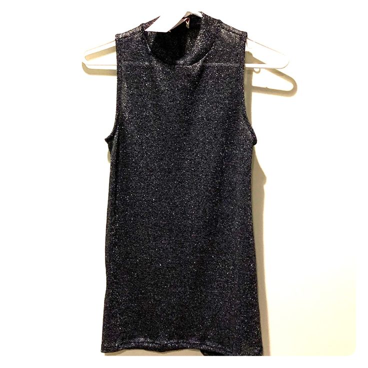 Lightweight Sweater Tank With Silver Detailing That Adds A Sexy Shimmer. This Top Is A Bit Sheer And Can Be Worn With A Bralette/Bandeau/Cami. It Is Tunic Length With Small Slits On The Sides And Can Easily Be Worn With Leggings! Great For A Night Out! Trendy Metallic Tops For Evening, Trendy Metallic Top For Evening, Shiny Stretch Top For Party, Sheen Tops For Party In Fall, Glamorous Fitted Tops With Sheen, Fall Party Tops With Sheen, Evening Stretch Glitter Tops, Shimmer Stretch Tops For Night Out, Chic Metallic Tops For Club