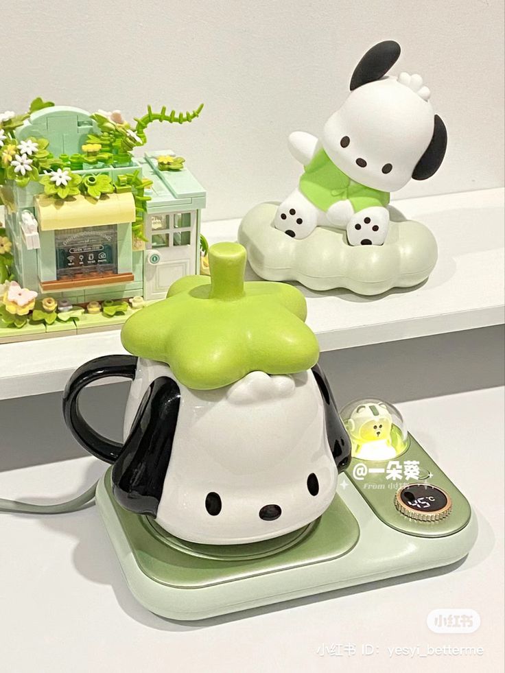 a tea pot with a dog figurine next to it