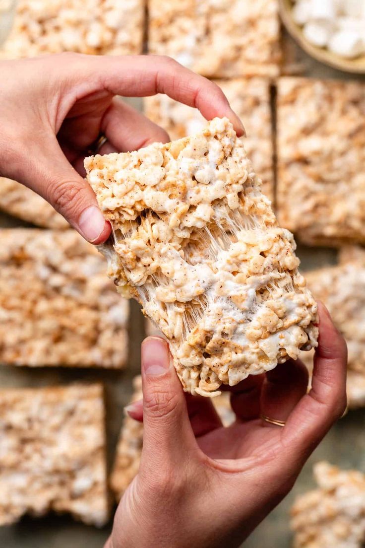 someone is holding some kind of granola bar in front of a wall full of other bars