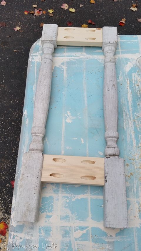 two wooden posts on top of a blue tile floor