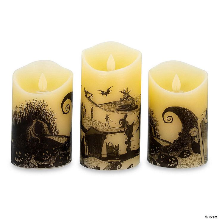 three candles with pictures on them sitting next to each other