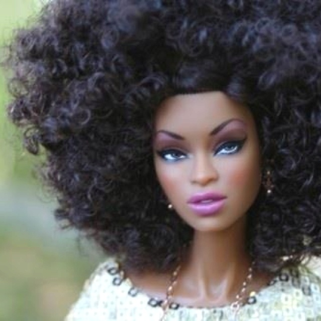 a close up of a doll with an afro