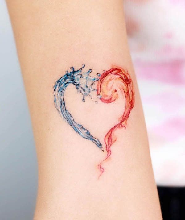 a woman's arm with a tattoo on it that is shaped like a heart