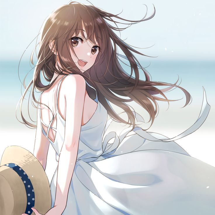 a woman in a white dress and hat sitting on the beach with her hair blowing in the wind