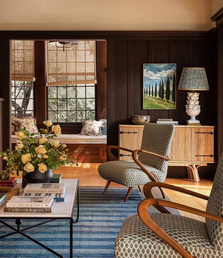 a living room filled with furniture and flowers on top of a blue carpeted floor