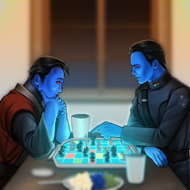 two people sitting at a table playing a game