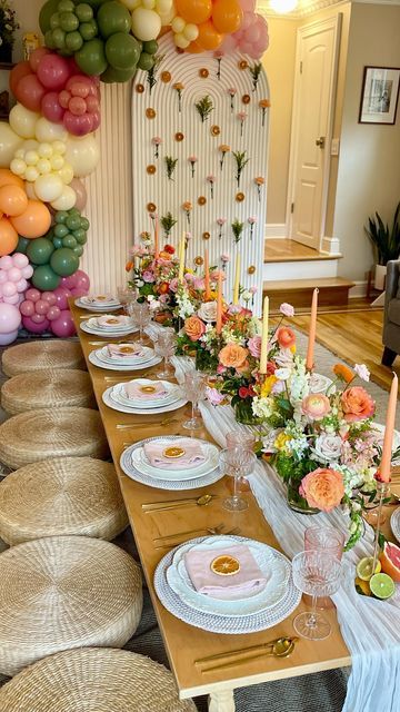 a long table is set with plates and flowers