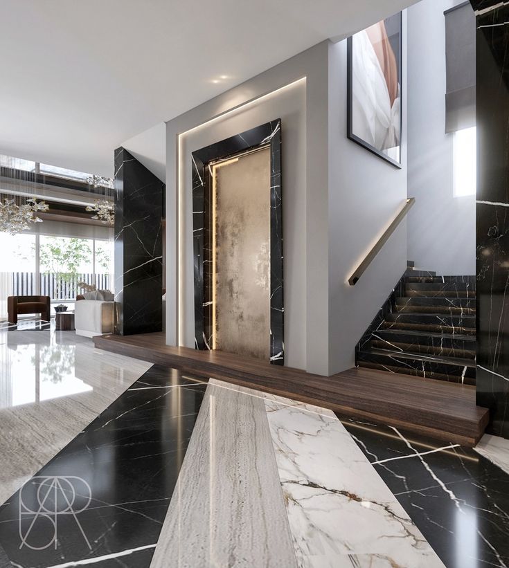 an elegant entry way with marble floors and stairs