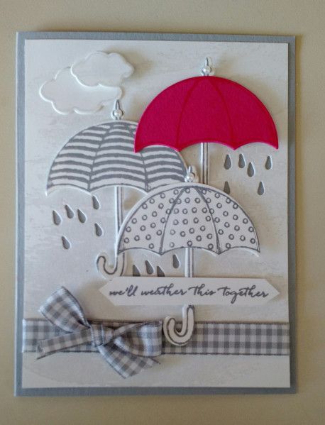 a card with an umbrella and checkered bow