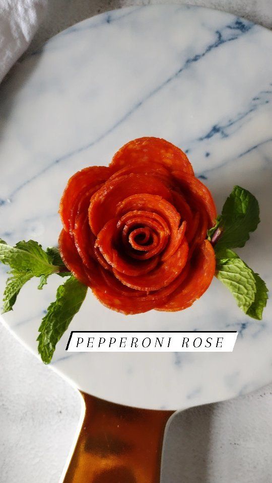 a rose on a marble plate with the words peperoni rose