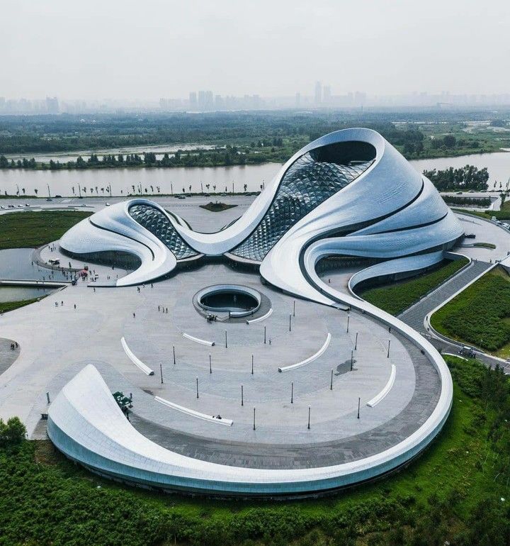 an aerial view of a modern building with curved roof