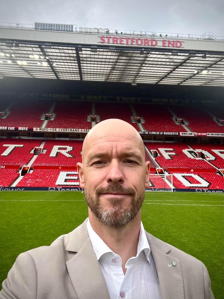 a man standing in front of a soccer field