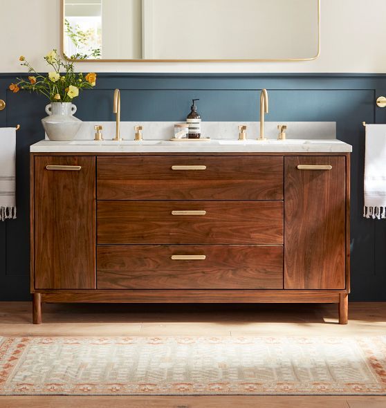 a bathroom vanity with two sinks and a large mirror over the sink in front of it